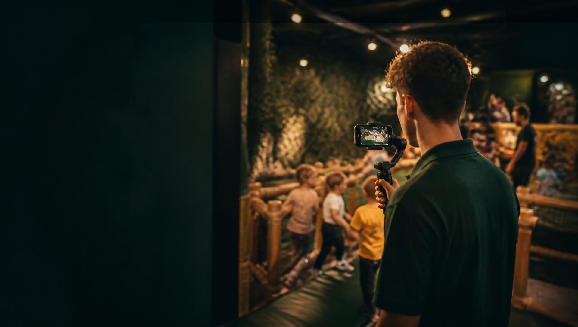 A venue staff member filming content inside an activity centre